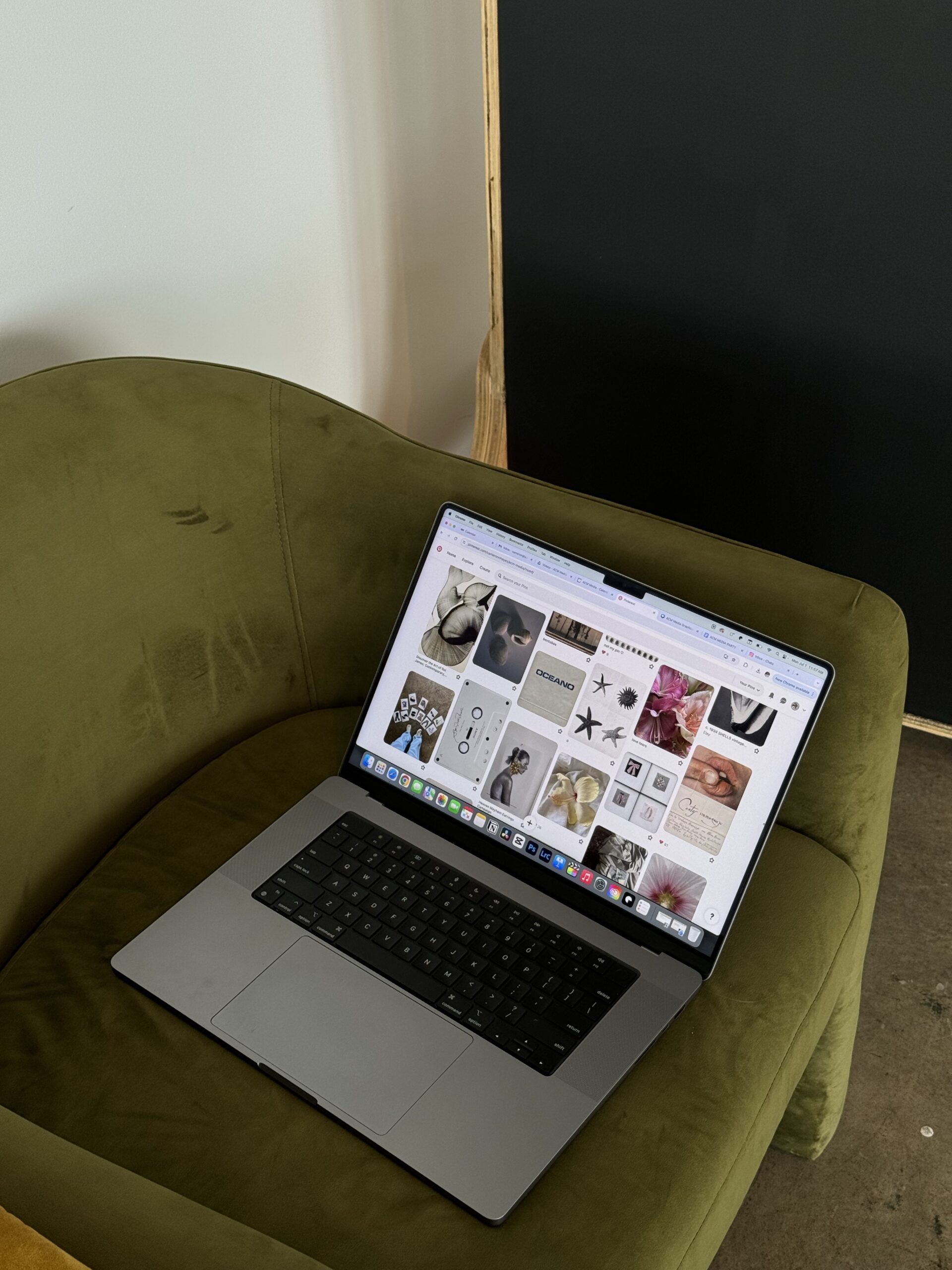 A laptop displaying a Pinterest mood board, sitting on an olive-green chair, showcasing inspiration for a $99 website design and Showit designer in Toronto.