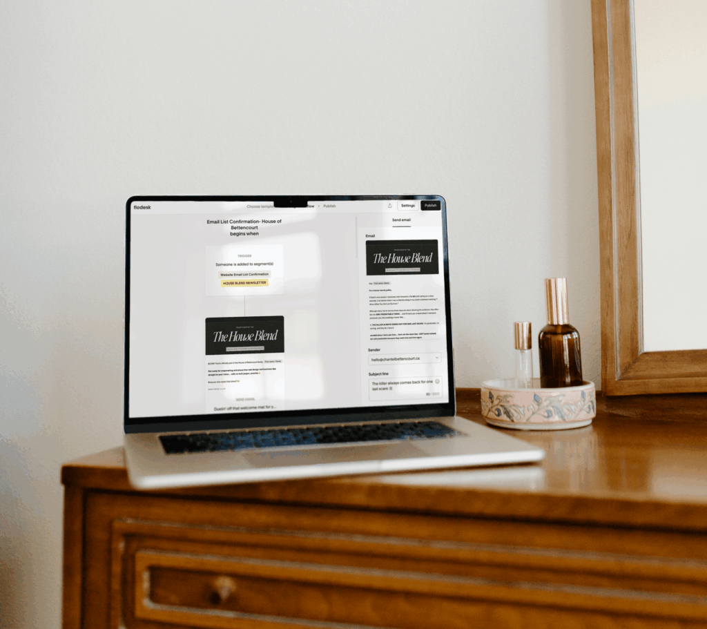 Laptop on a wooden desk in a modern home office, displaying an email welcome sequence template, representing seamless automation with Flodesk Thrivecart integration.